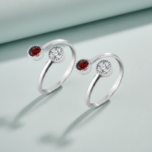 Top open silver toe ring with red and white gemstone