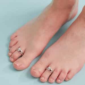 silver toe ring with red and white gemstone heart shape